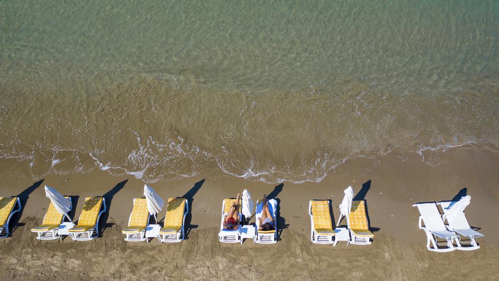 Golden sandy beach in Side, Turkey with sunbeds and clear sea